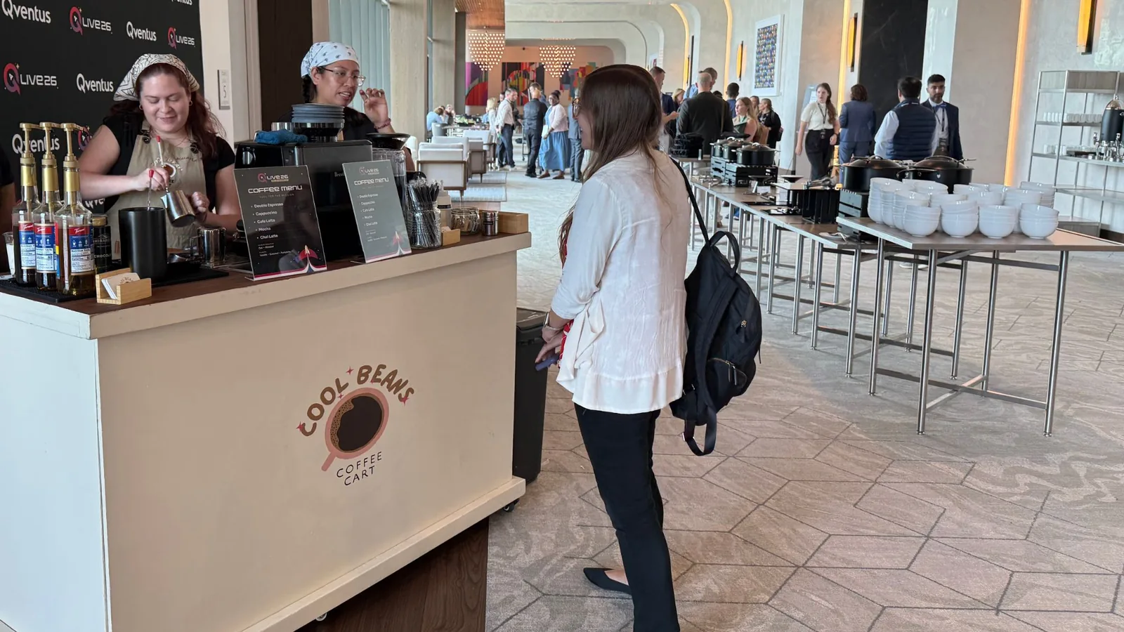 Conference guests ordering from the Cool Beans cart beside the buffet line