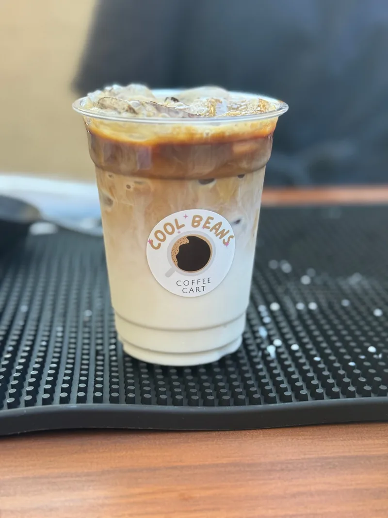 Layered iced latte in a Cool Beans cup
