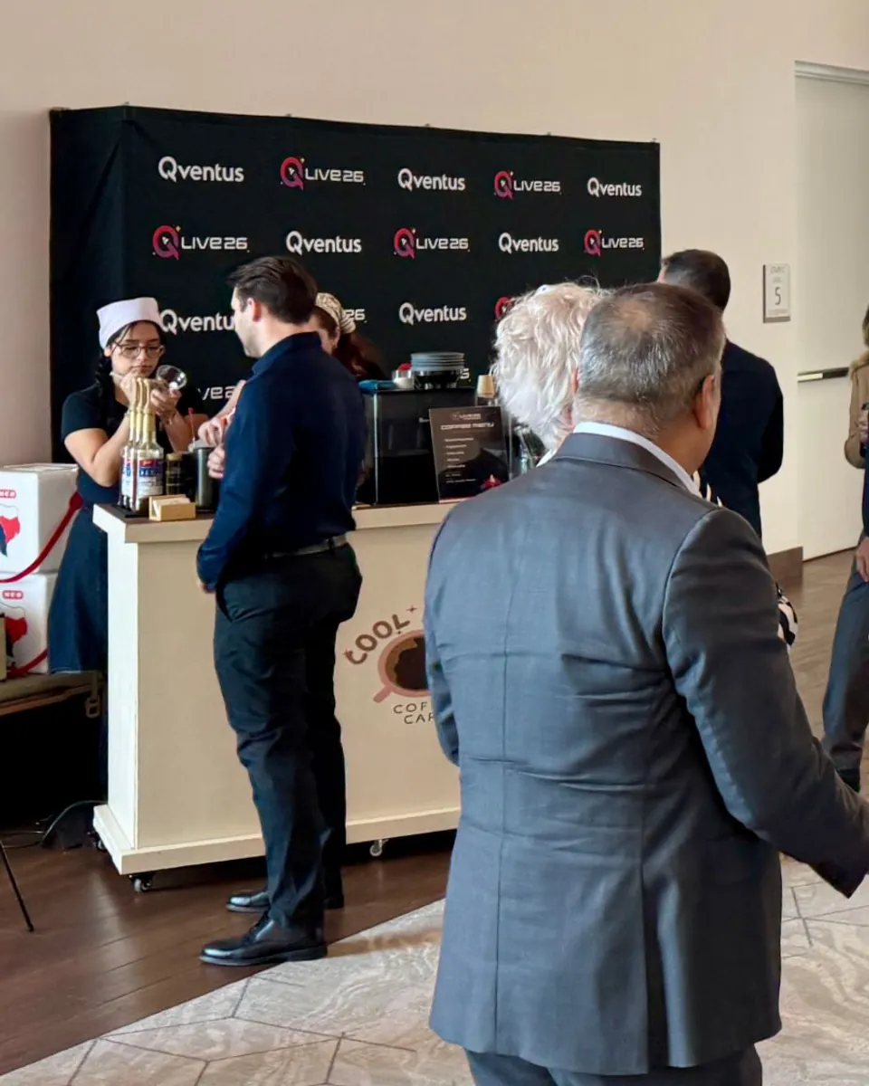 Cool Beans Coffee Cart with a client-branded backdrop and custom menu at a corporate conference